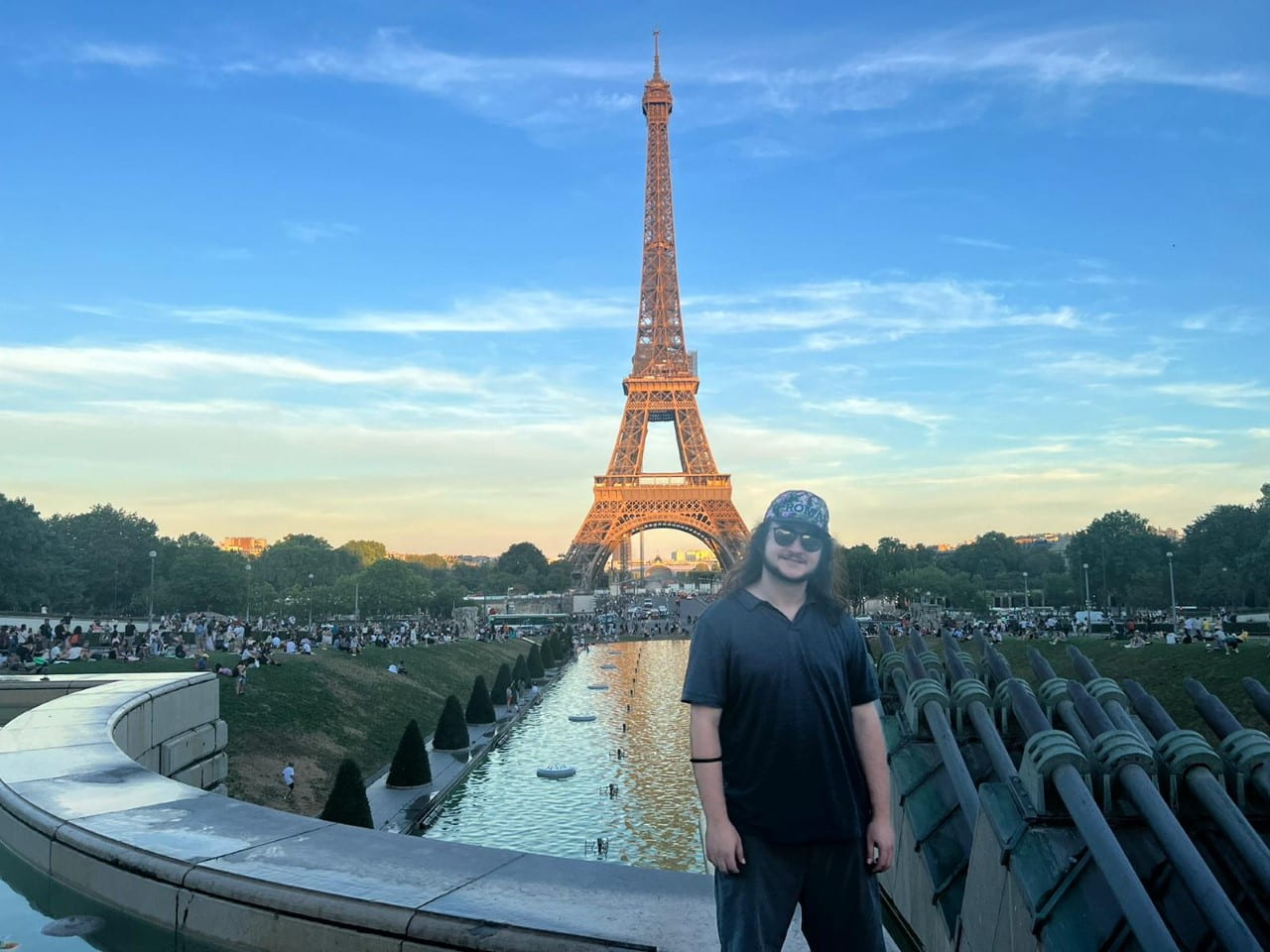 SISRM fellow Adam D. posing in front of the Eiffel Tower.
