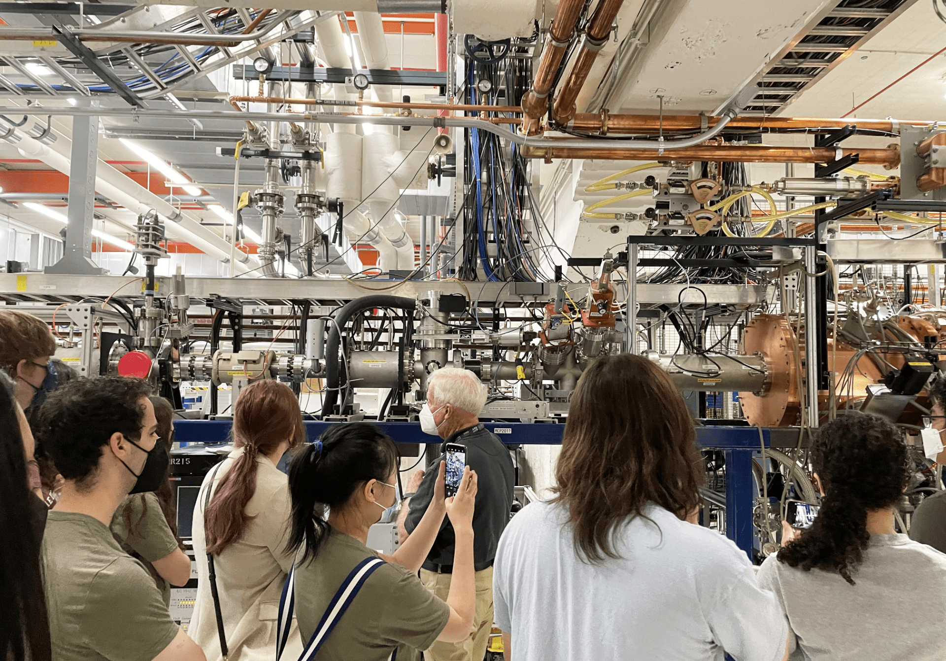 SISRM fellows look at parts of the particle accelerator at the Argonne National Laboratory